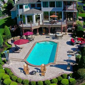 drone view of a backyard patio and pool deck